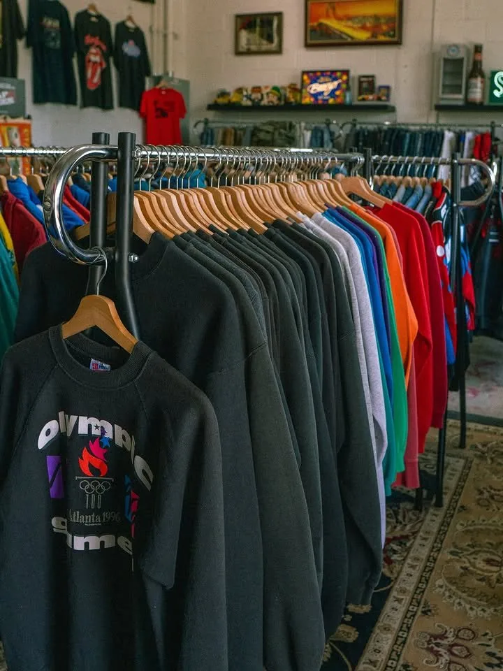 A rack of vintage crewneck sweatshirts, Atlanta 1996 Olympics in front