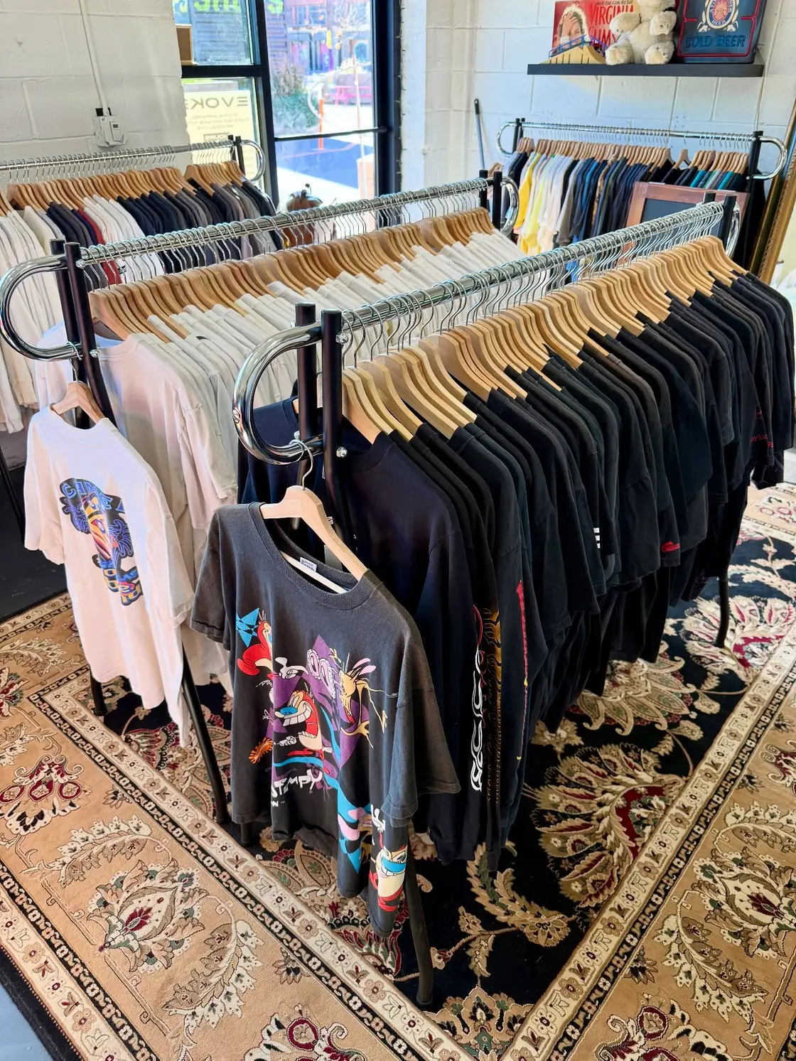 Racks of vintage tees in the shop, a Ren and Stimpy tee hanging up front