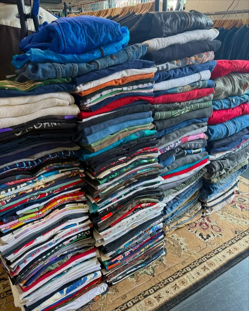 Tall stacks of folded vintage tees on a table